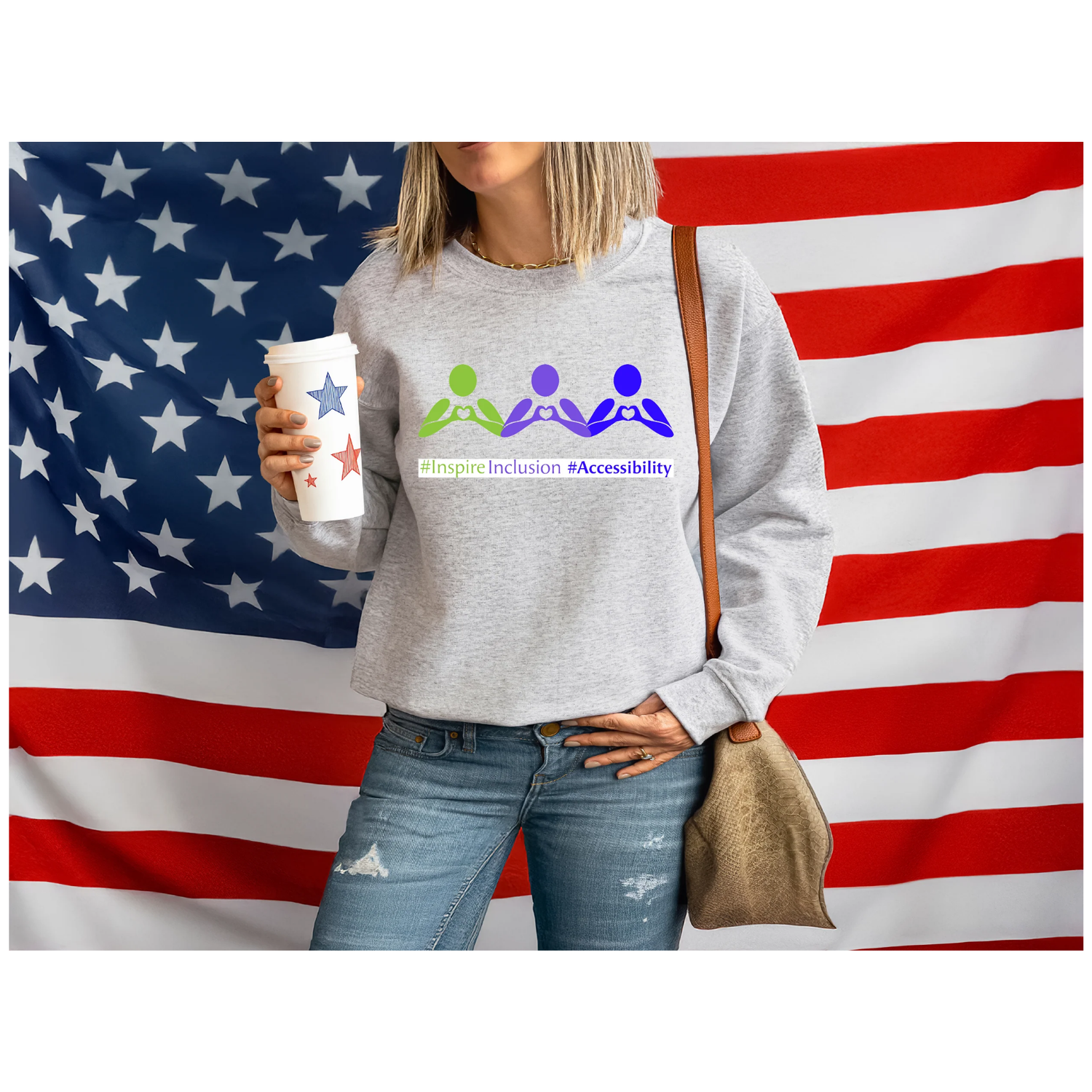 woman in gray dtf sweatshirt with #InspireInclusion #Accessibility standing in front of the american flag