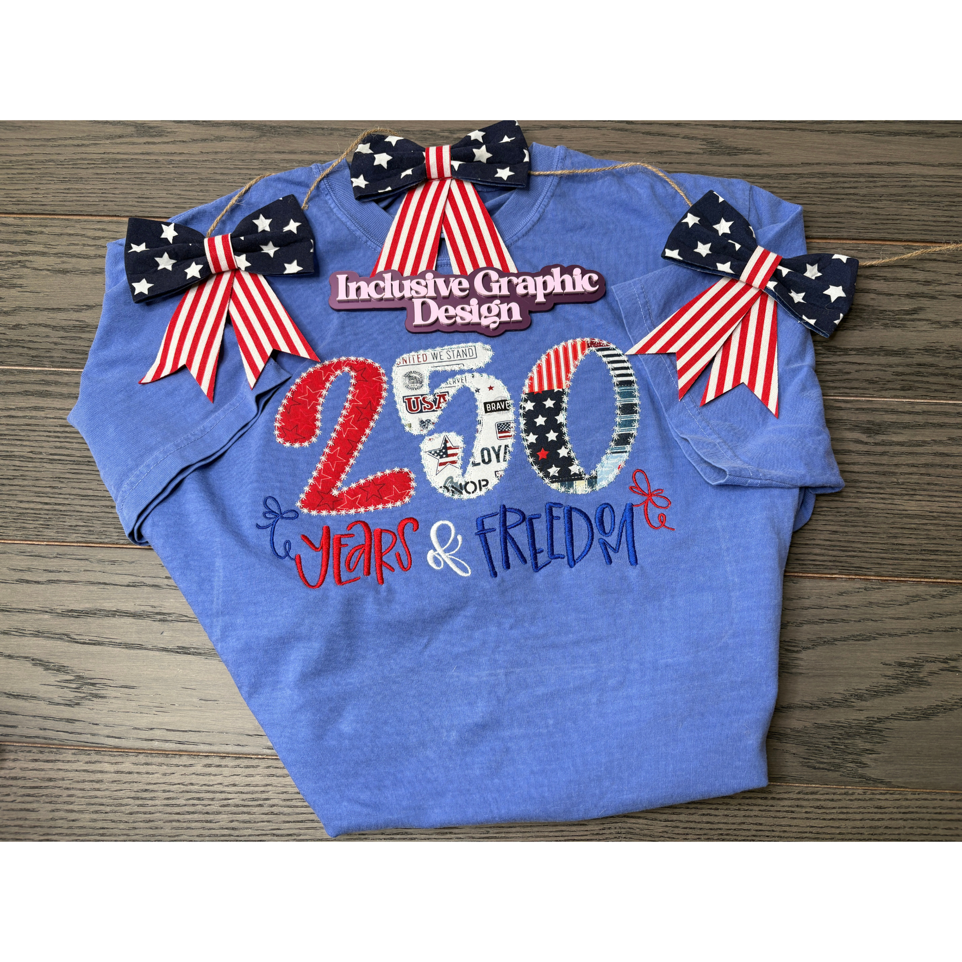 Blue t-shirt with patriotic design featuring numbers and text on a wooden surface