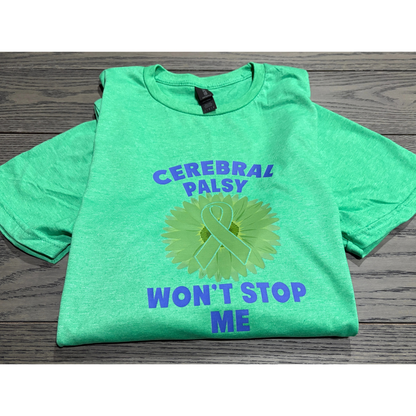 Green t-shirt with 'Cerebral Palsy Won't Stop Me' text and symbol on a wooden surface
