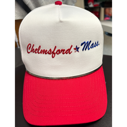 a white hat with a red brim with embroidered text chelmsford in red and Mass in blue with a red, white and blue star seperating the 2 texts. 