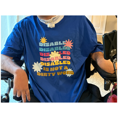 Person wearing a blue shirt with colorful text in a wheelchair.