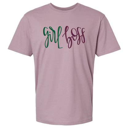 A dusty purple short-sleeve t-shirt featuring text 'girl boss' embroidered across the chest in green and dark purple cursive script.