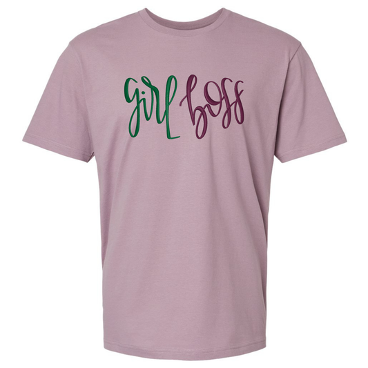 A dusty purple short-sleeve t-shirt featuring text 'girl boss' embroidered across the chest in green and dark purple cursive script.