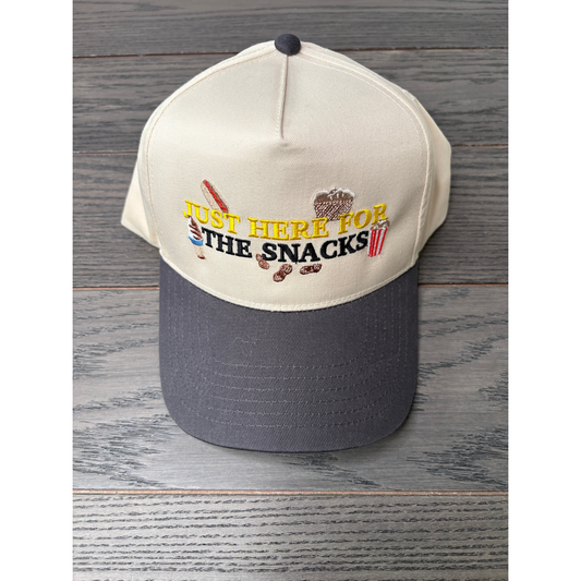 Just here for the snacks embroidered on a tan and gray hat