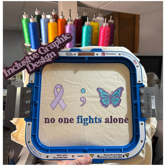 Embroidery hoop with designs of a ribbon, semicolon, and butterfly, accompanied by the text 'no one fights alone'.