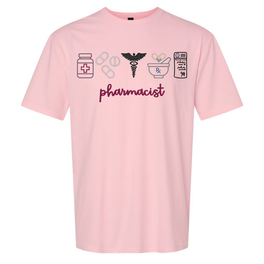 Pink t-shirt with pharmacist-themed graphics and text on a white background