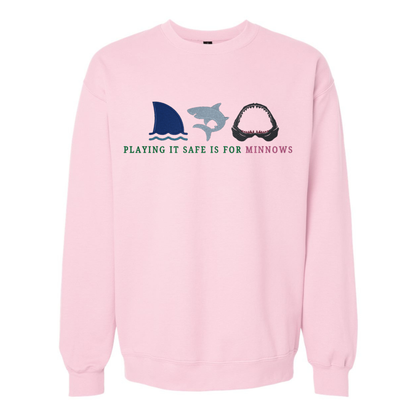 Pink sweatshirt with shark and dolphin graphic and text on a white background