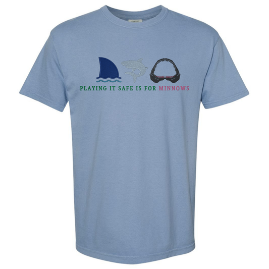 Light blue t-shirt with fishing-themed graphics and text on a white background
