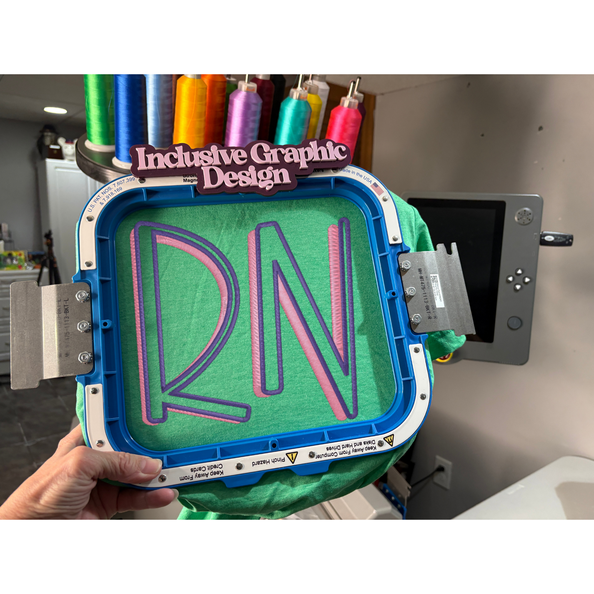 3D printing process with 'RN' design on a green material, held by a hand.