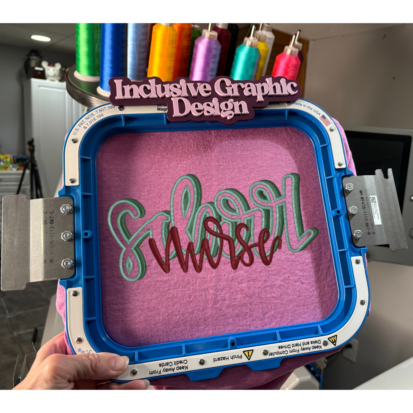 Embroidery hoop with 'Inclusive Graphic Design' text and colorful thread spools in the background.
