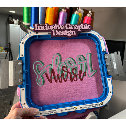 Embroidery hoop with 'Inclusive Graphic Design' text and colorful thread spools in the background.