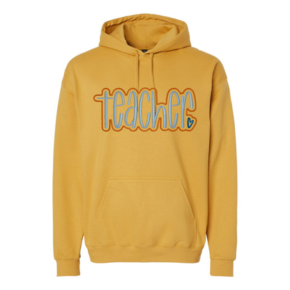 yellow sweatshirt with teacher appliqued on it